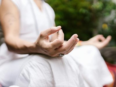 Close-up of hands in a precise yoga mudra gesture.